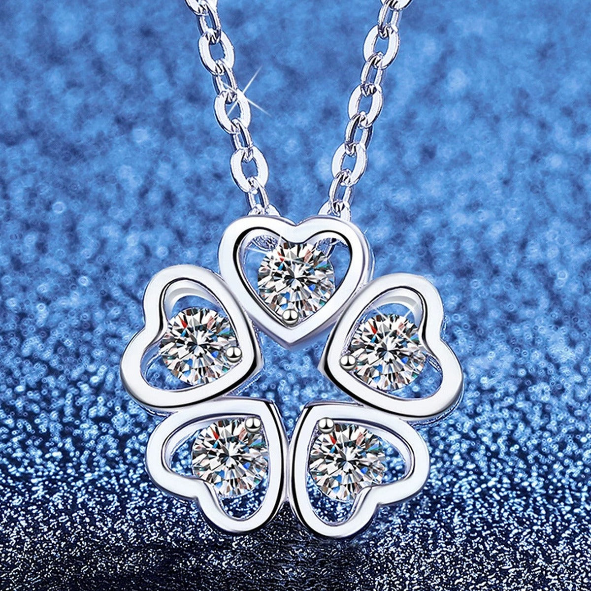 Clover Moissanite Pendant Necklace in Platinum-Plated S925 Sterling Silver blue background angled view