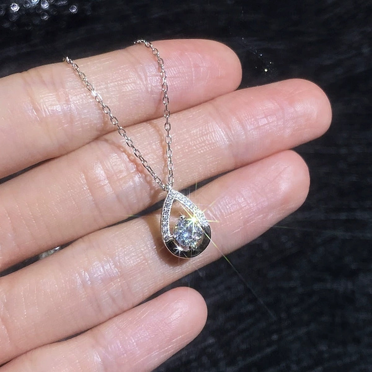 Teardrop Moissanite Pendant Necklace with Cubic Zirconia in Platinum-Plated S925 Sterling Silver worn on neckline by model