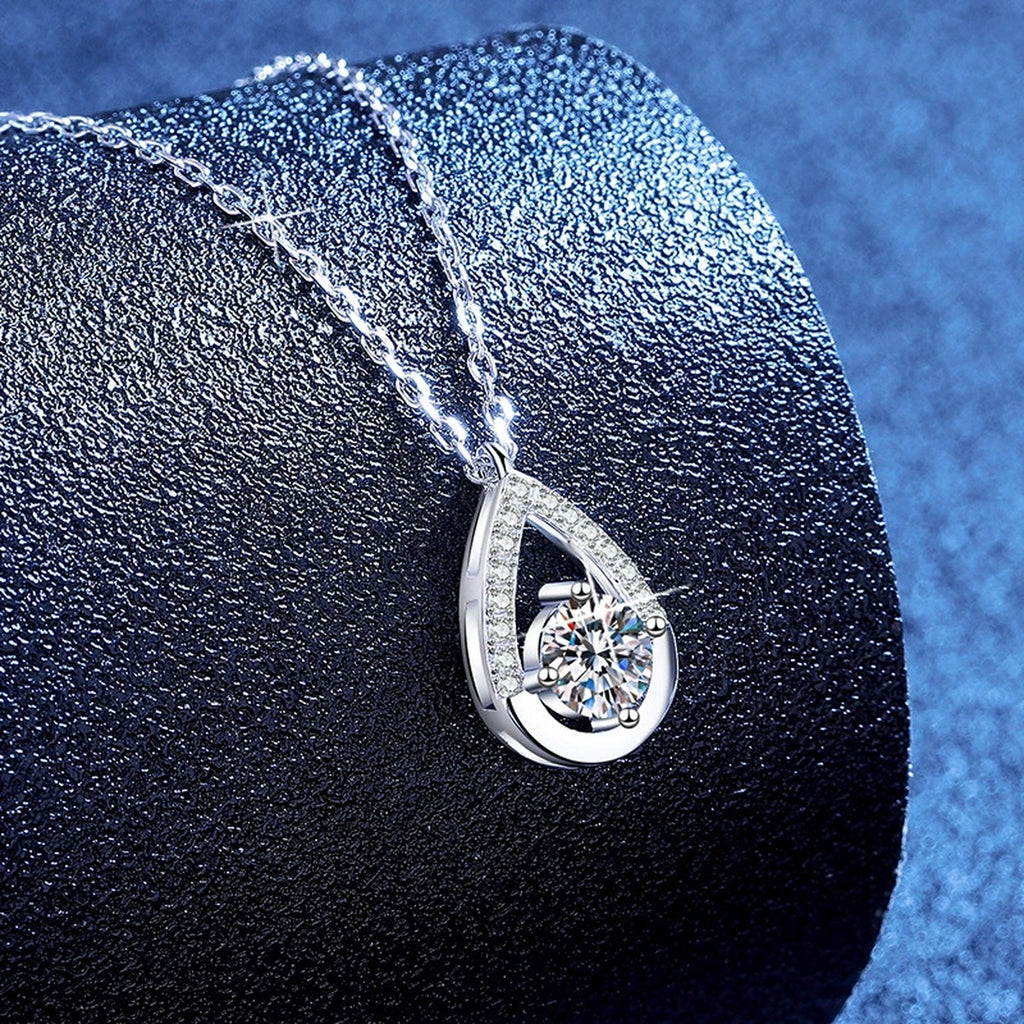 Teardrop Moissanite Pendant Necklace with Cubic Zirconia in Platinum-Plated S925 Sterling Silver blue background angled view