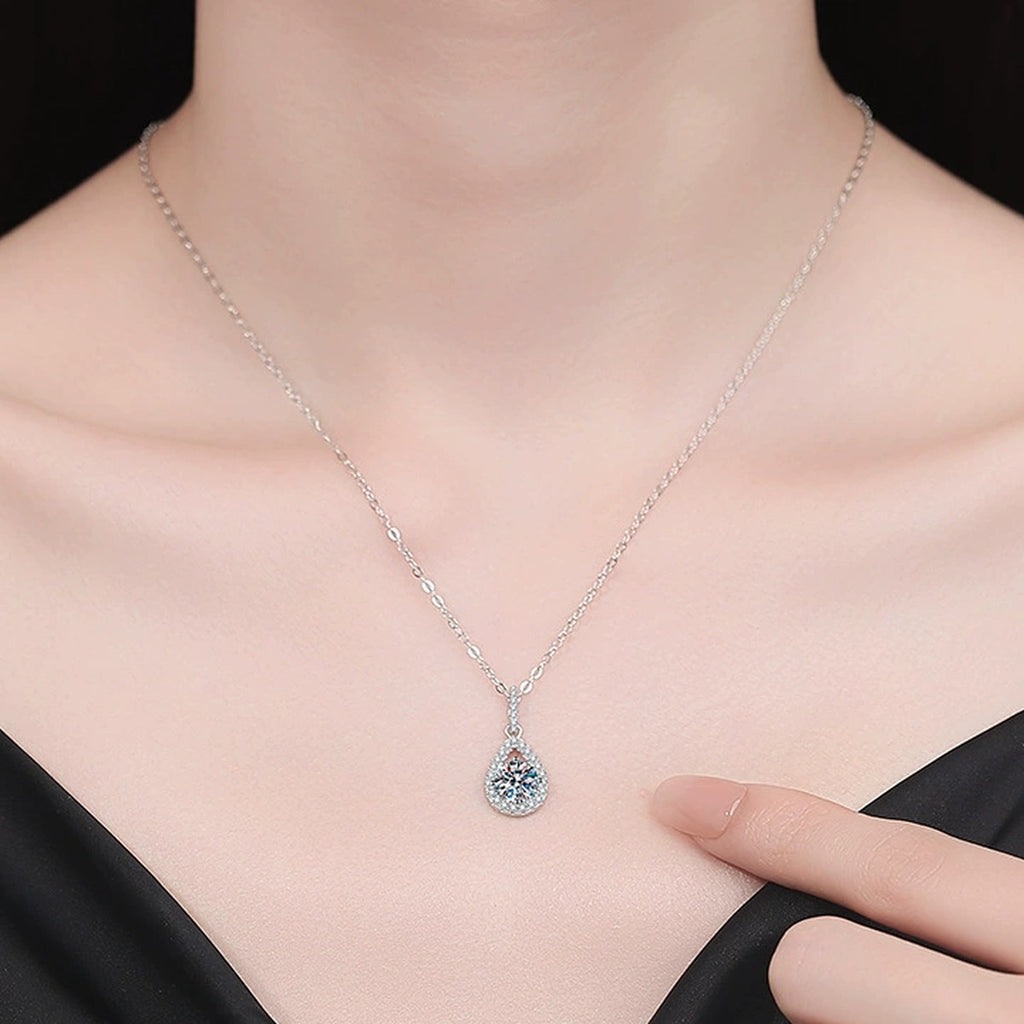 Pear Drop Moissanite Pendant Necklace with Cubic Zirconia in Platinum-Plated S925 Sterling Silver worn on neckline by model