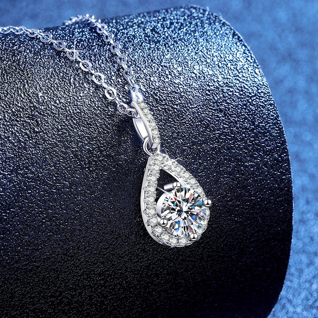 Pear Drop Moissanite Pendant Necklace with Cubic Zirconia in Platinum-Plated S925 Sterling Silver blue background angled view
