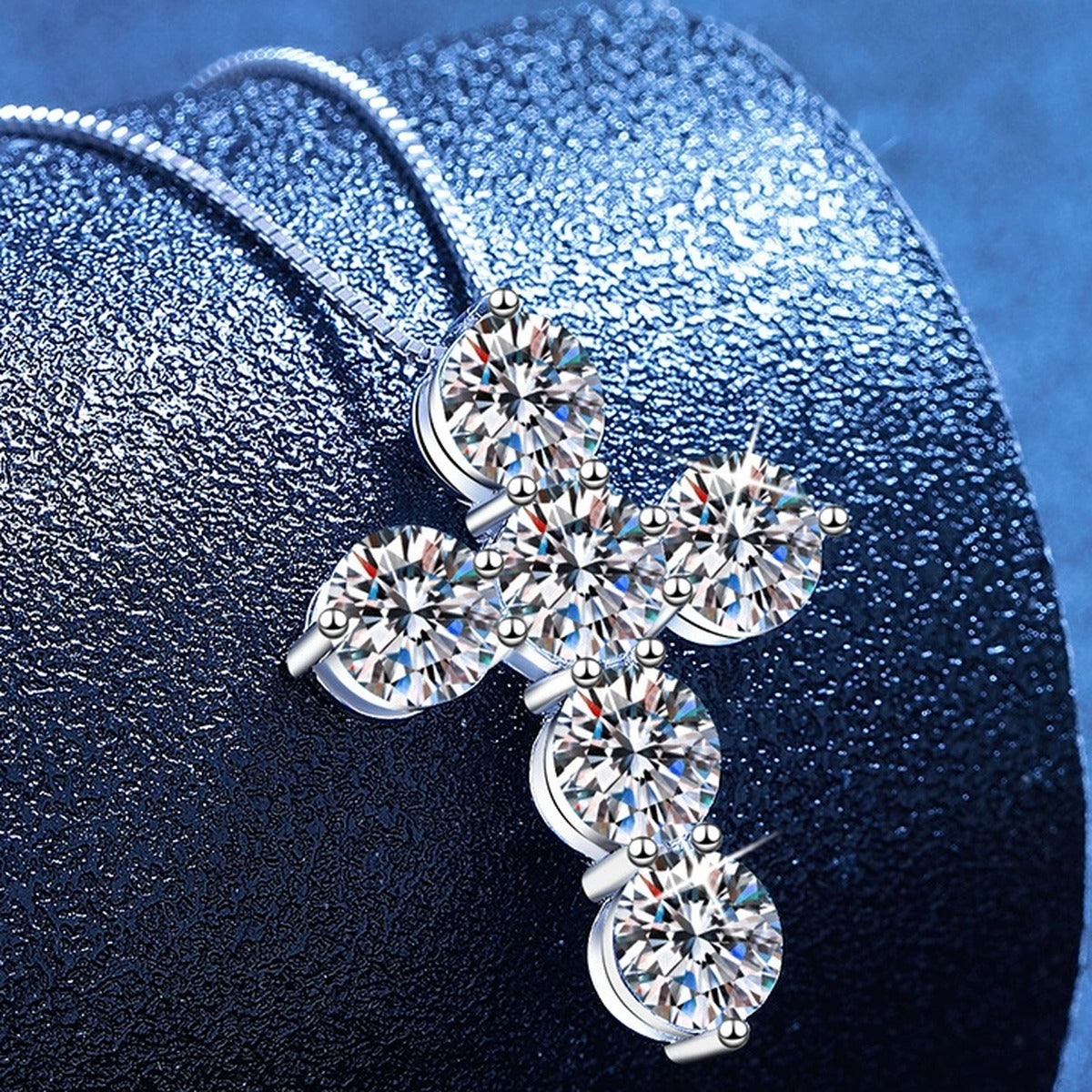 Cross Moissanite Pendant Necklace in Platinum-Plated S925 Sterling Silver blue background angled view