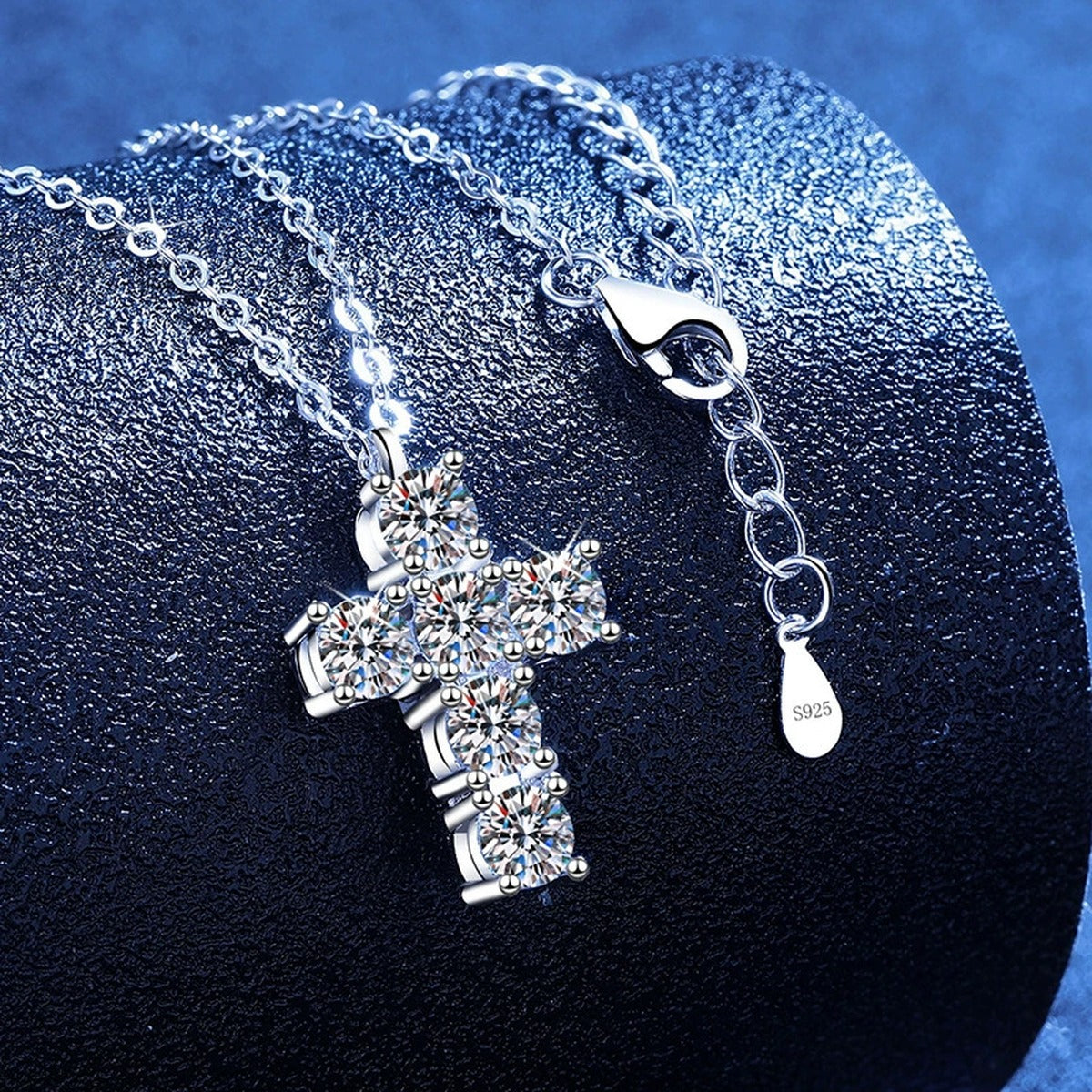 Cross Moissanite Pendant Necklace in Platinum-Plated S925 Sterling Silver blue background angled view
