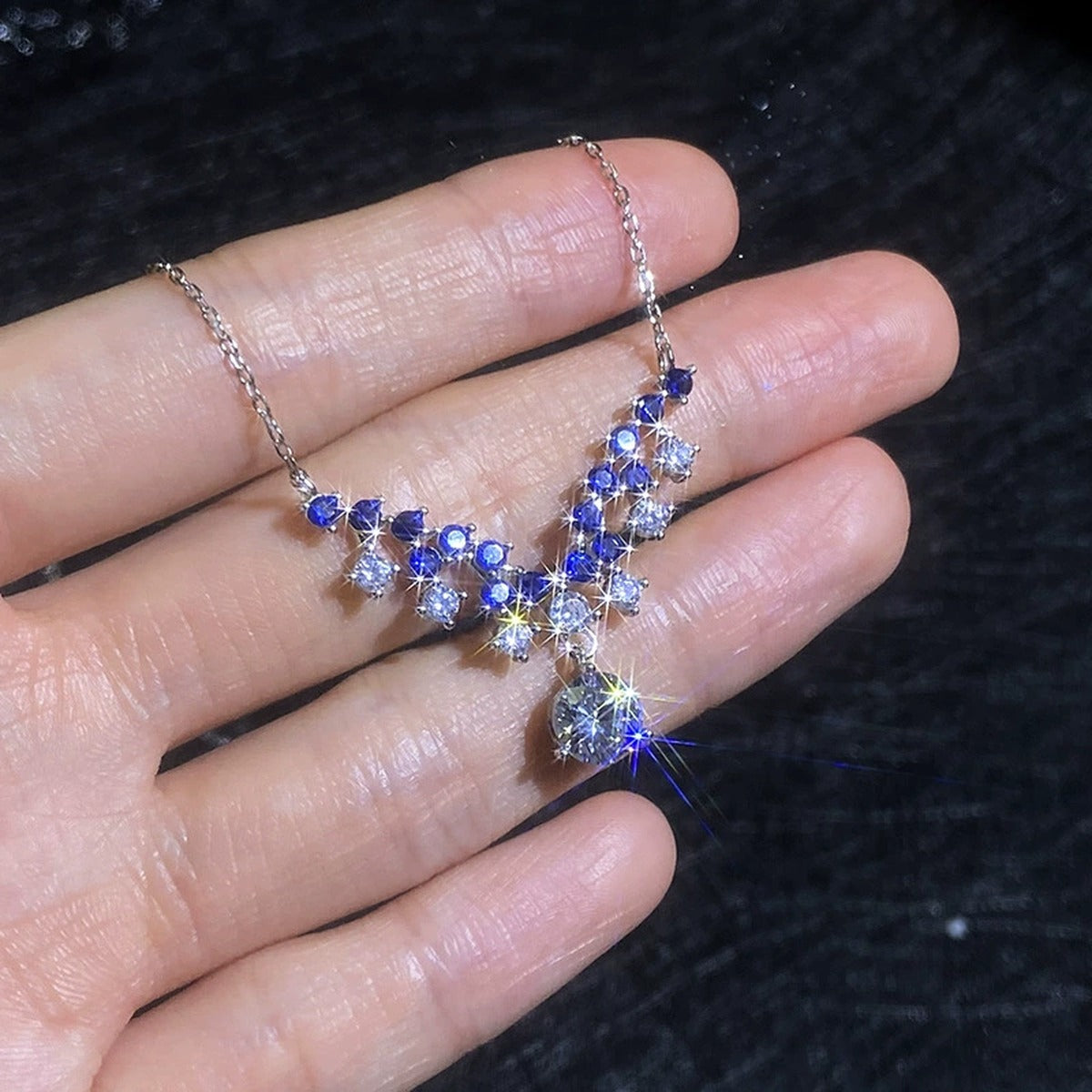 Blue Accent Graduated Moissanite Drop Necklace with Cubic Zirconia in Platinum-Plated S925 Sterling Silver close-up product detail view