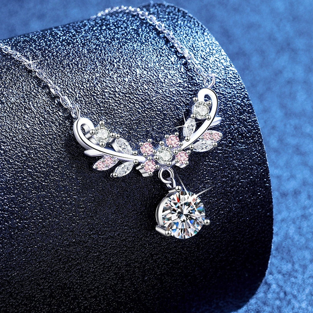 Pink Accent Wing Moissanite Pendant Necklace with Cubic Zirconia in Platinum-Plated S925 Sterling Silver blue background angled view