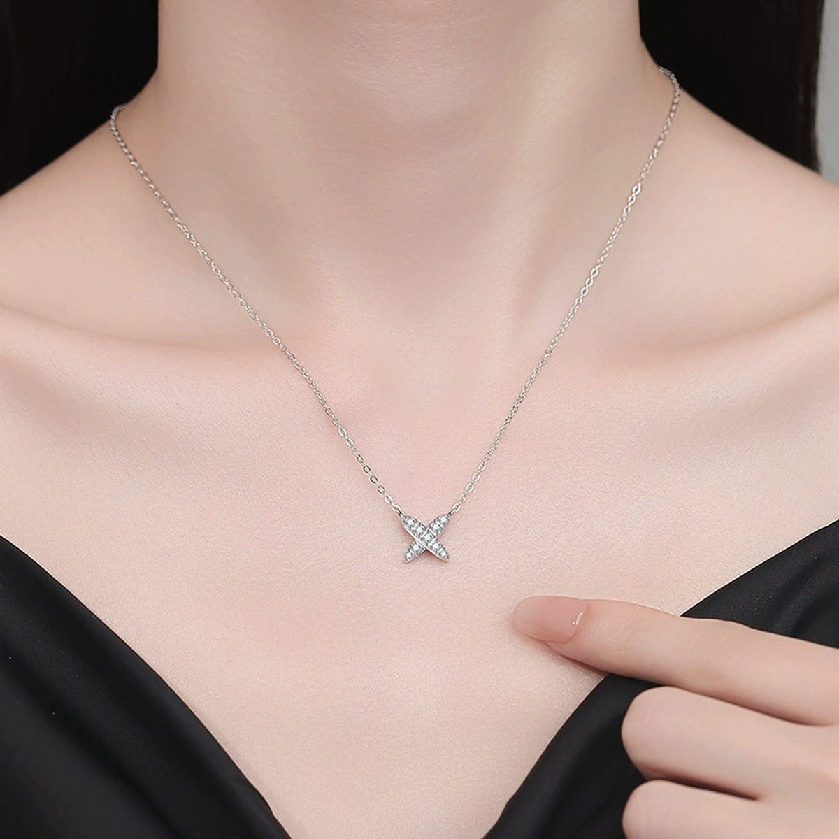 X Motif Moissanite Pendant Necklace in Platinum-Plated S925 Sterling Silver worn on neckline by model