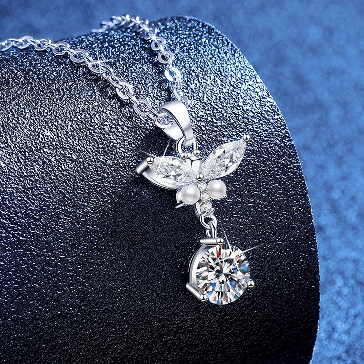 Wing Pearl Moissanite Pendant Necklace with Cubic Zirconia in Platinum-Plated S925 Sterling Silver blue background angled view