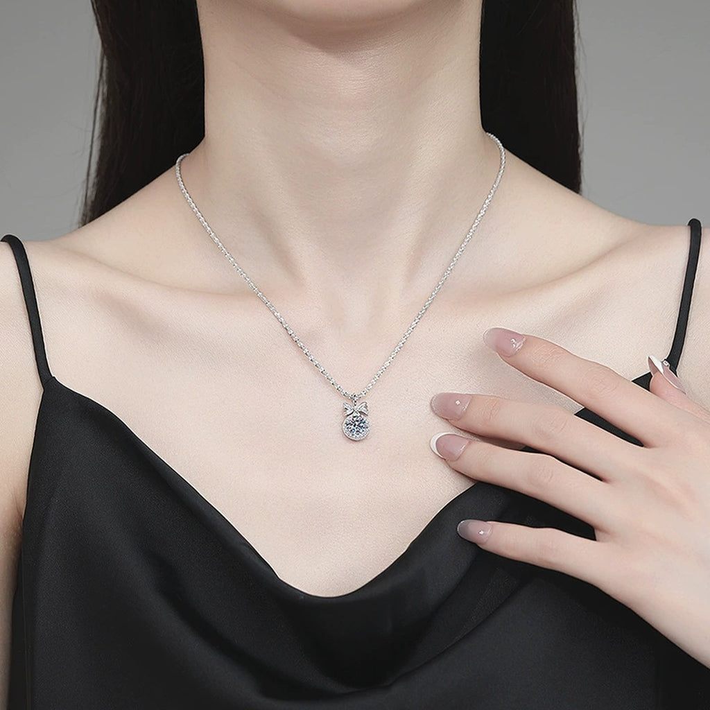 Bow Moissanite Pendant Necklace with Cubic Zirconia in Platinum-Plated S925 Sterling Silver worn on neckline by model