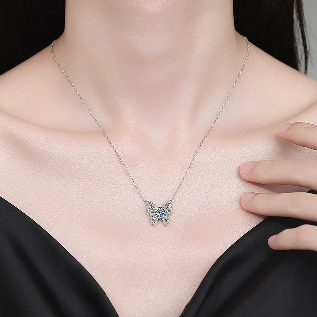 Butterfly Moissanite Pendant Necklace with Cubic Zirconia in Platinum-Plated S925 Sterling Silver worn on neckline by model