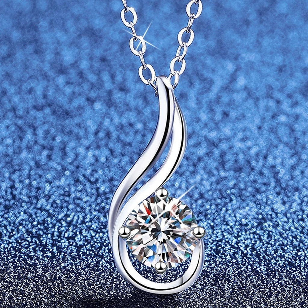 Flame Teardrop Moissanite Pendant Necklace in Platinum-Plated S925 Sterling Silver blue background angled view