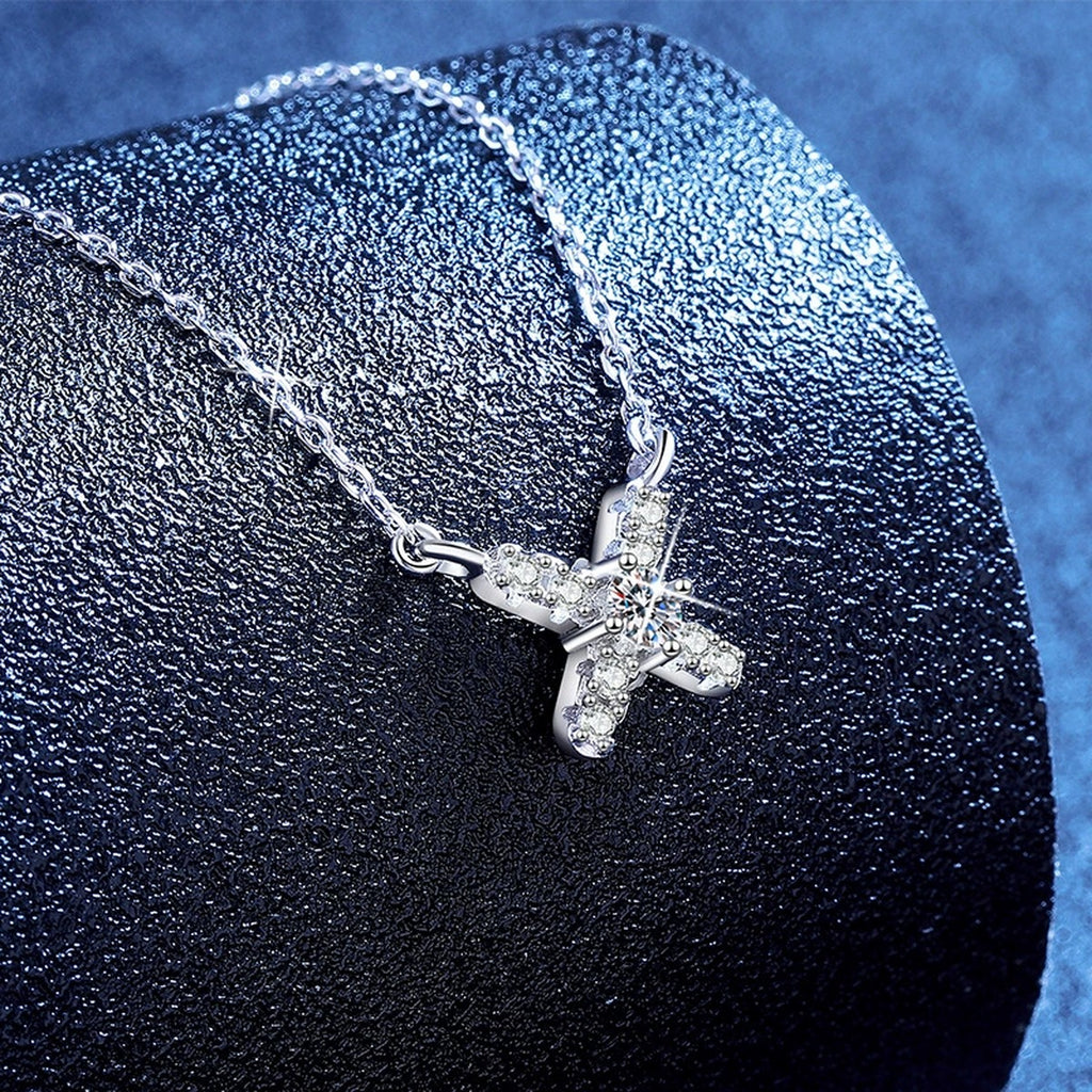 Petite X Moissanite Pendant Necklace with Cubic Zirconia in Platinum-Plated S925 Sterling Silver blue background product view