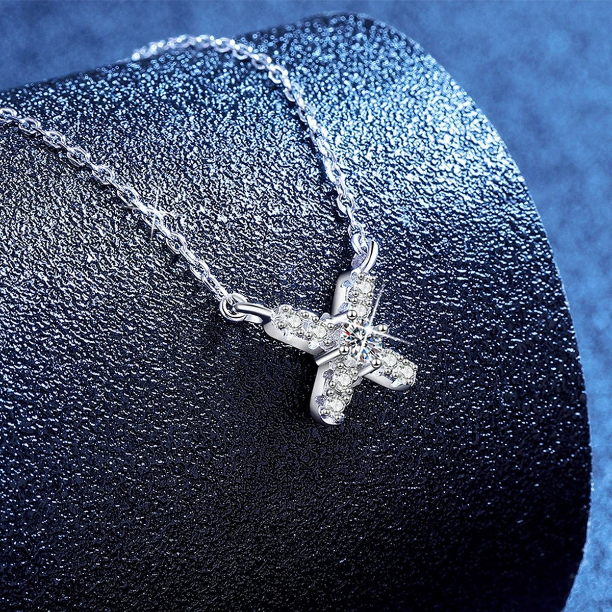 Petite X Moissanite Pendant Necklace with Cubic Zirconia in Platinum-Plated S925 Sterling Silver blue background product view