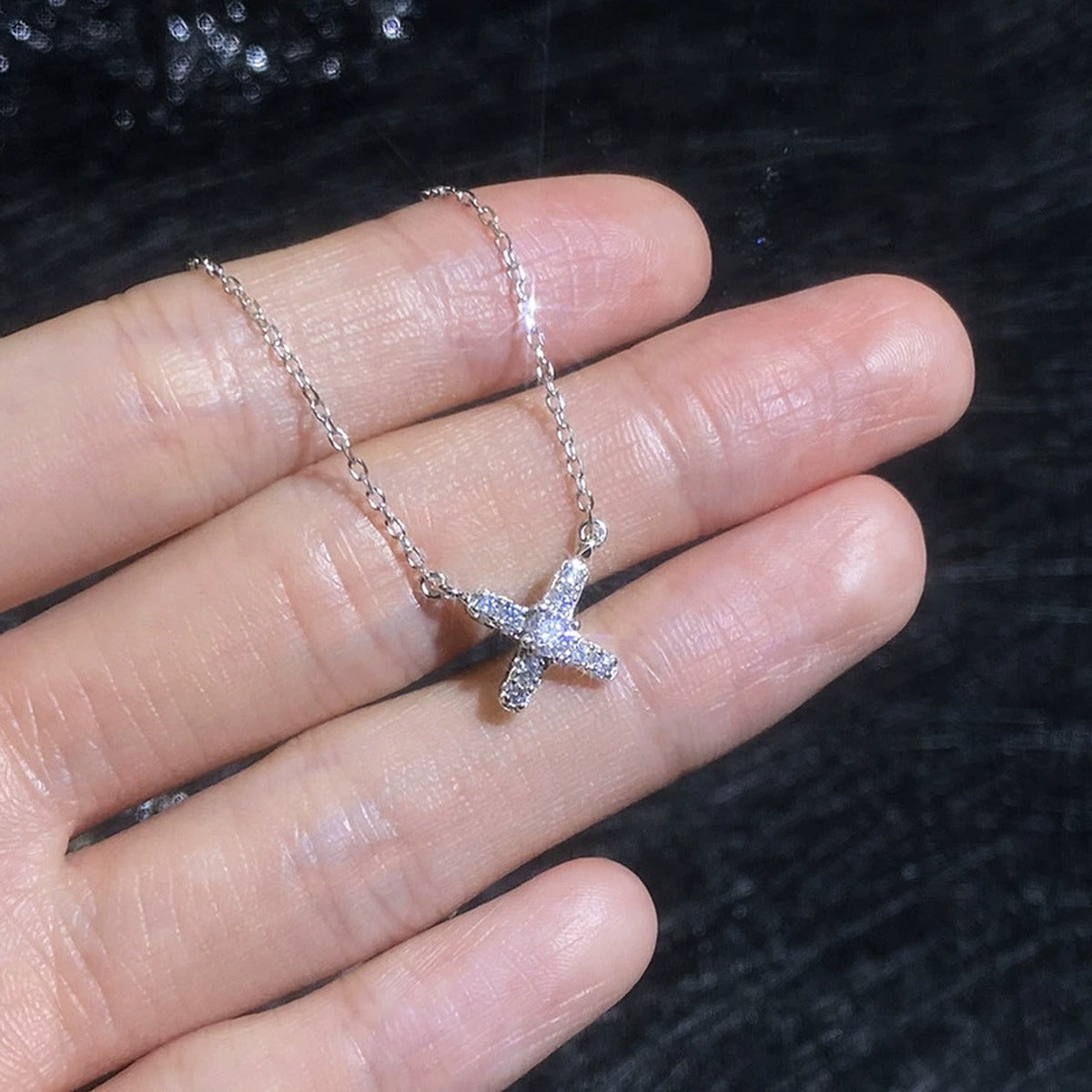 Petite X Moissanite Pendant Necklace with Cubic Zirconia in Platinum-Plated S925 Sterling Silver close-up product detail view