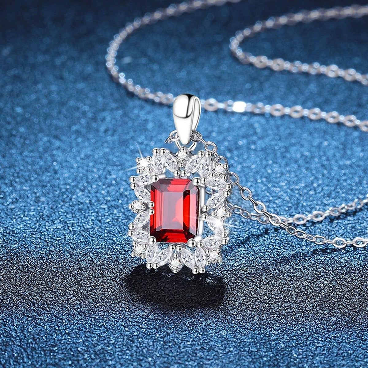 Emerald Cut Lab-Grown Gemstone and Moissanite Pendant Necklace in White Gold-Plated S925 Sterling Silver blue background angled view