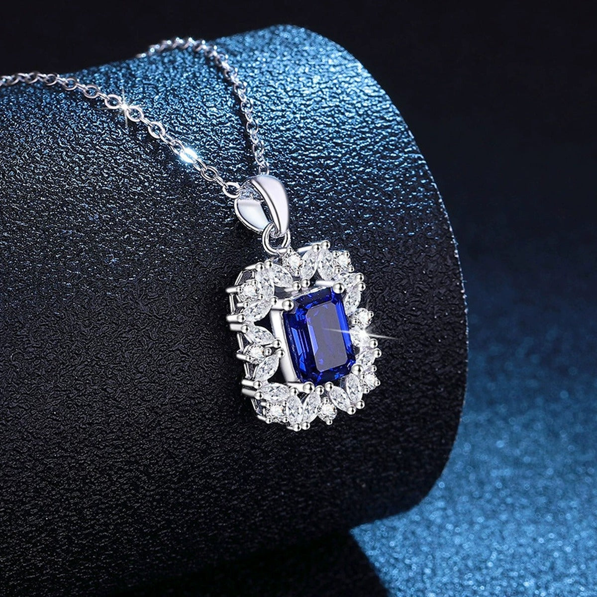 Emerald Cut Lab-Grown Gemstone and Moissanite Pendant Necklace in White Gold-Plated S925 Sterling Silver blue background styling view