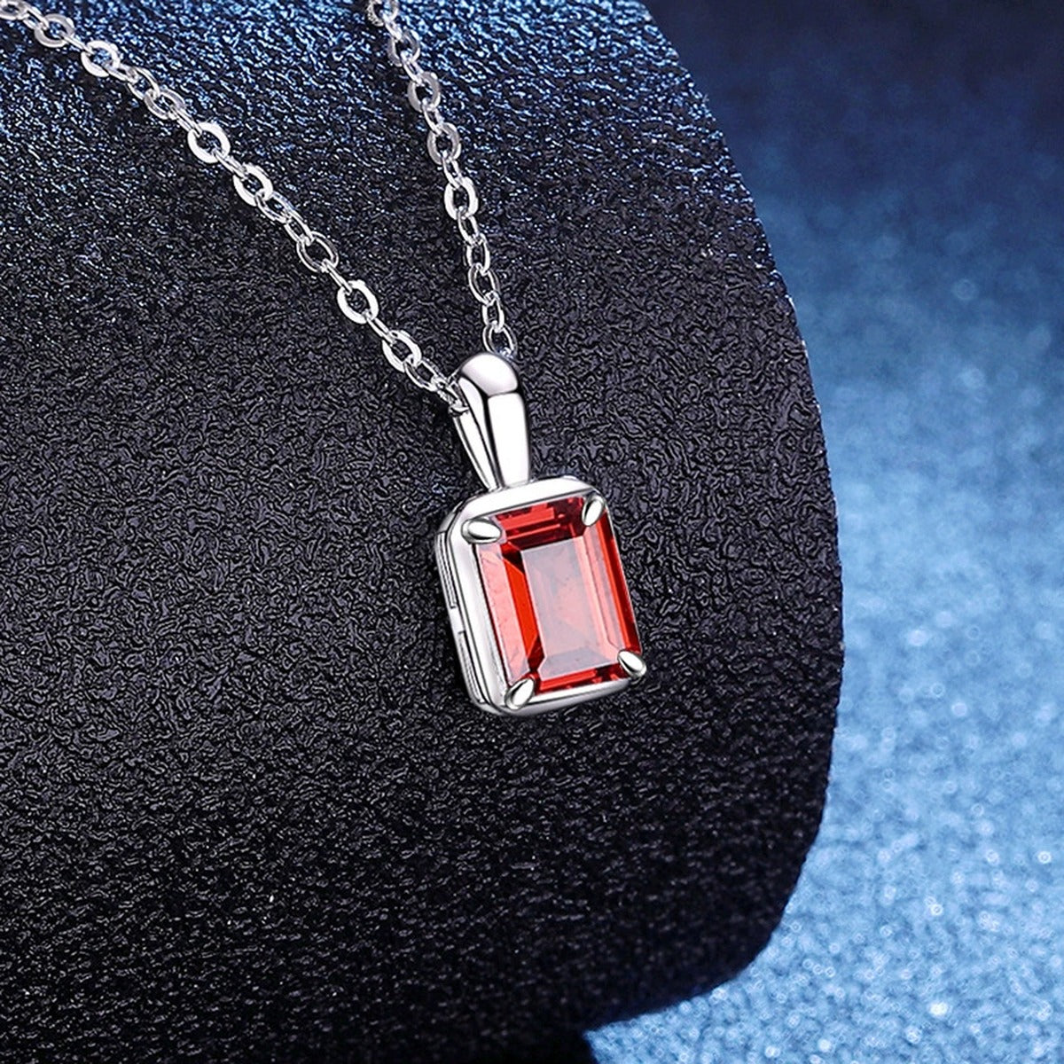 Emerald Cut Lab-Grown Gemstone and Moissanite Pendant Necklace in White Gold-Plated S925 Sterling Silver blue background angled view
