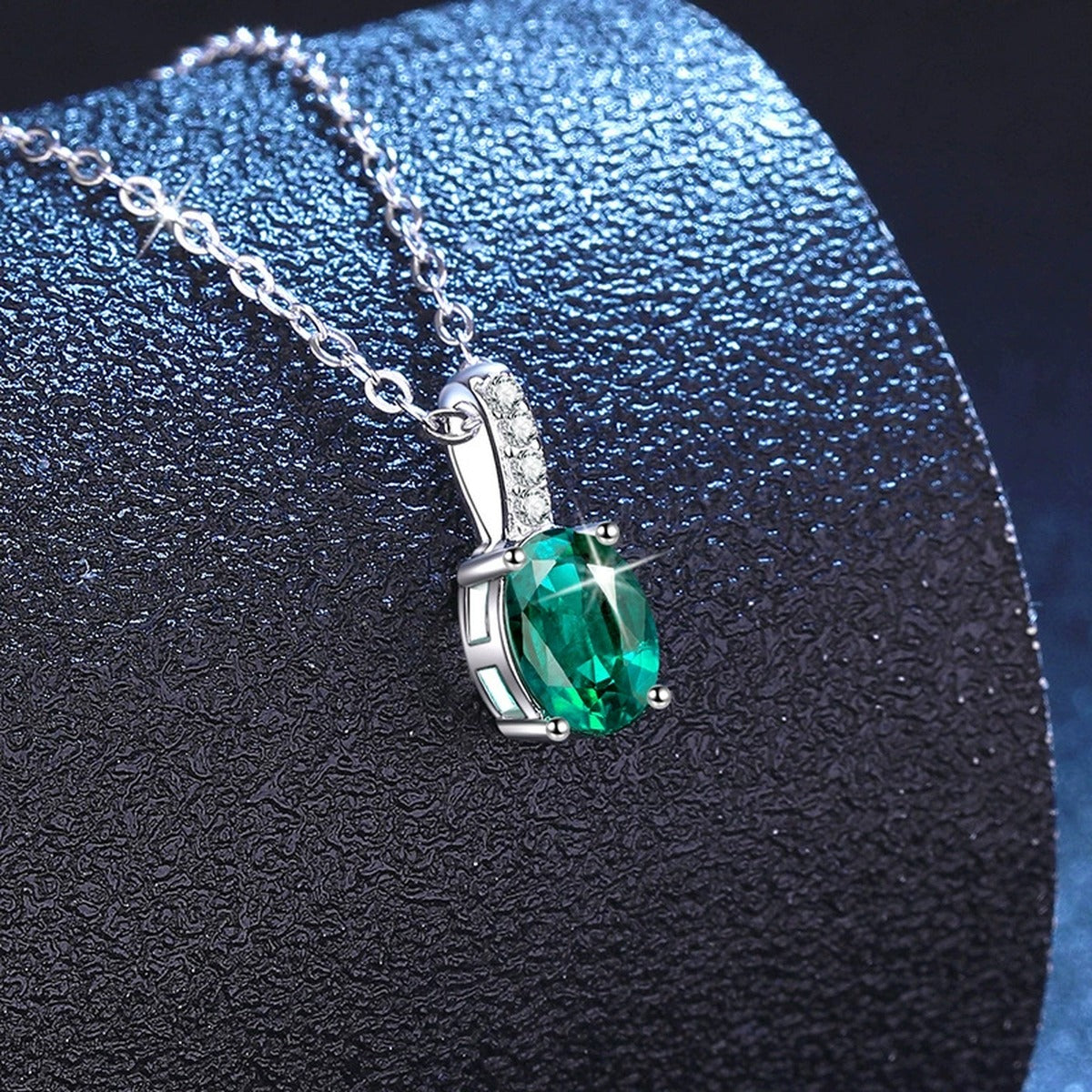 Oval Lab-Grown Gemstone and Moissanite Drop Necklace in White Gold-Plated S925 Sterling Silver blue background angled view