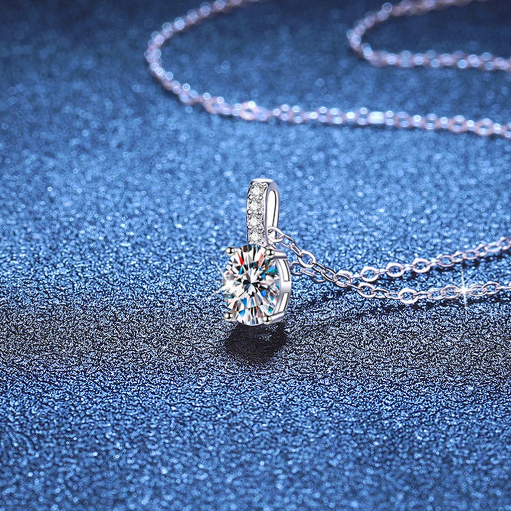 Oval Lab-Grown Gemstone and Moissanite Drop Necklace in White Gold-Plated S925 Sterling Silver blue background close-up view