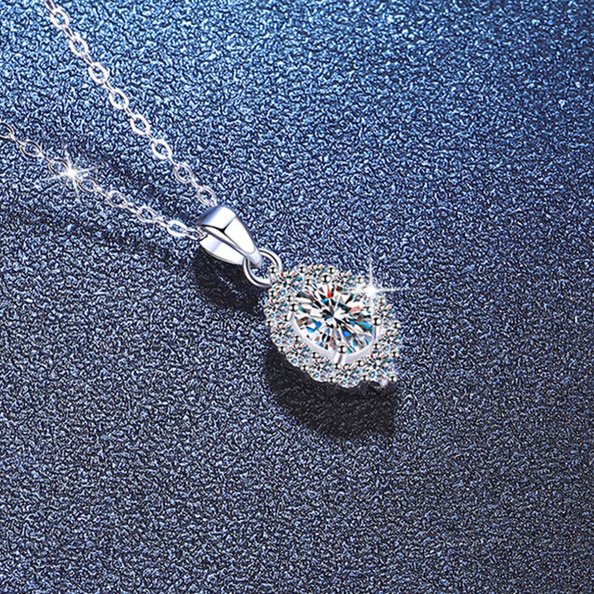 Oval Halo Lab-Grown Gemstone and Moissanite Pendant Necklace in White Gold-Plated S925 Sterling Silver blue background angled view