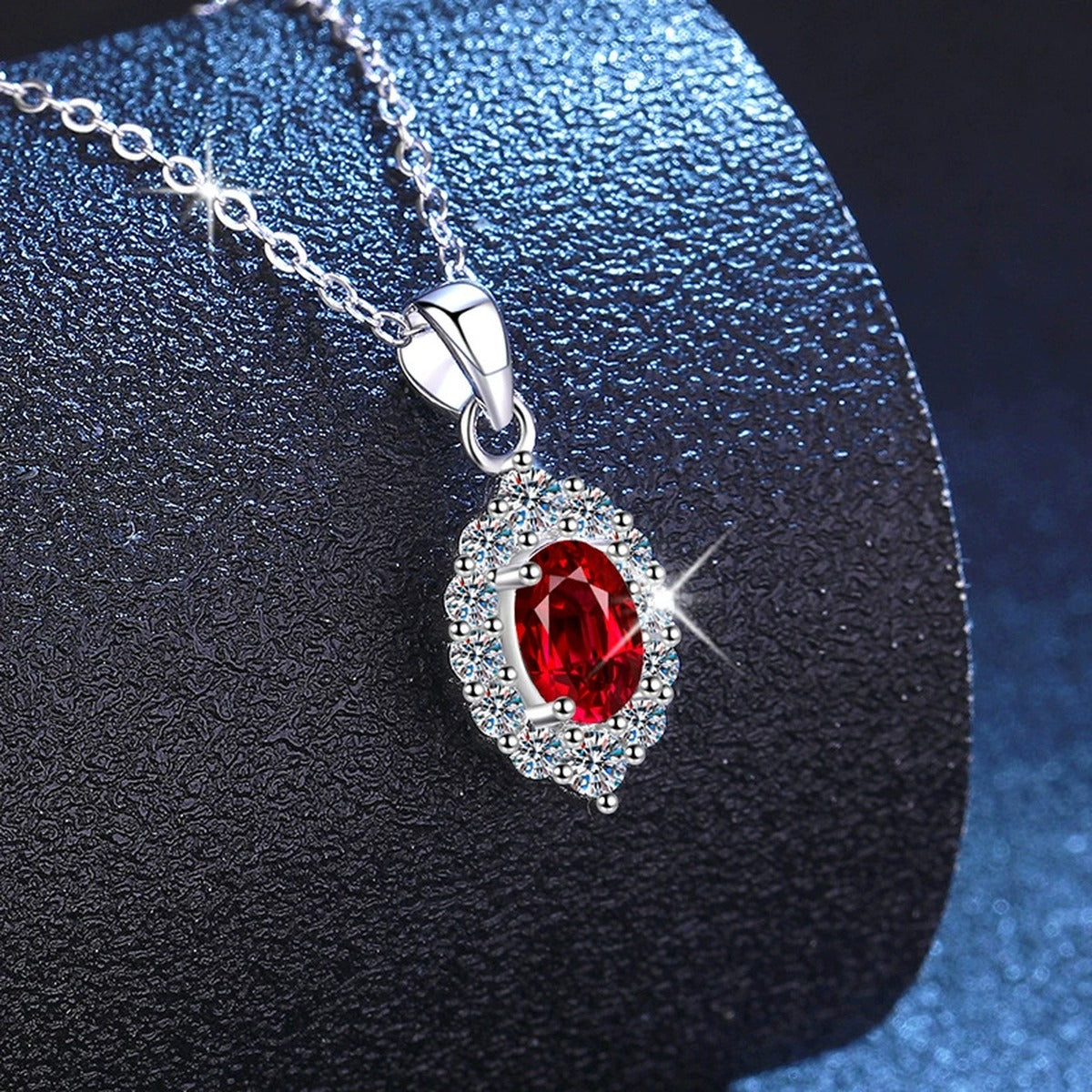 Oval Halo Lab-Grown Gemstone and Moissanite Pendant Necklace in White Gold-Plated S925 Sterling Silver blue background close-up view