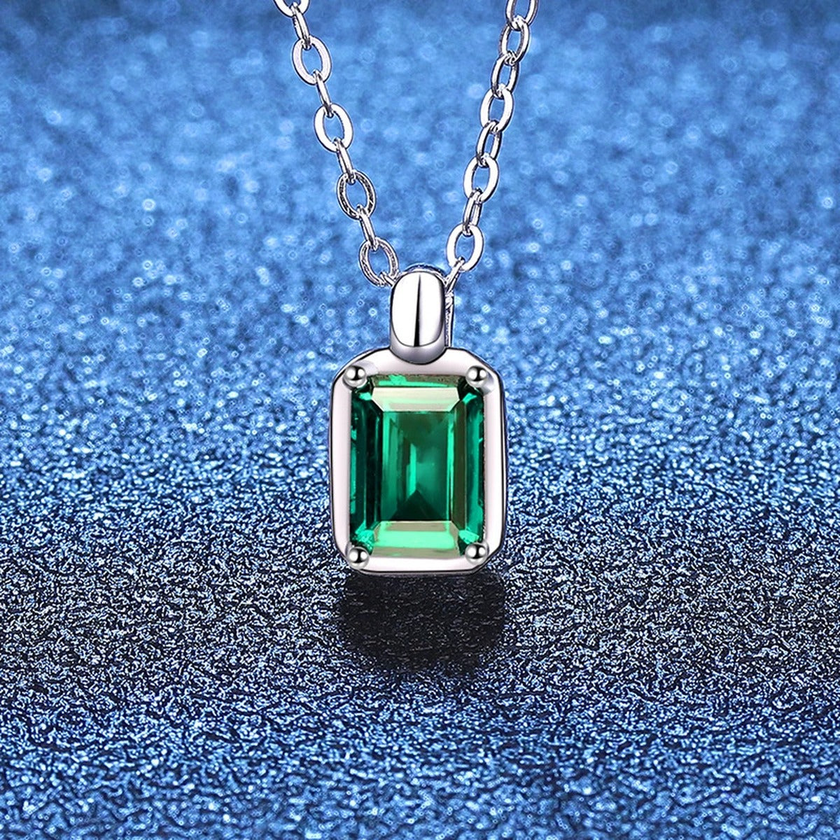 Emerald Cut Lab-Grown Gemstone and Moissanite Pendant Necklace in White Gold-Plated S925 Sterling Silver blue background angled view