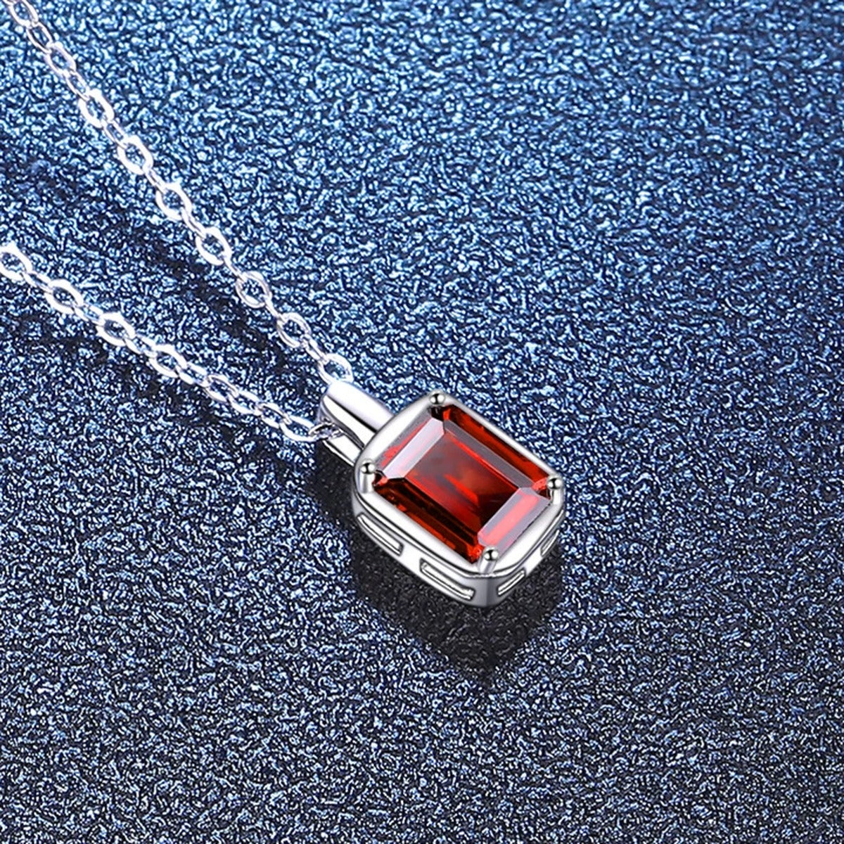 Emerald Cut Lab-Grown Gemstone and Moissanite Pendant Necklace in White Gold-Plated S925 Sterling Silver blue background close-up view