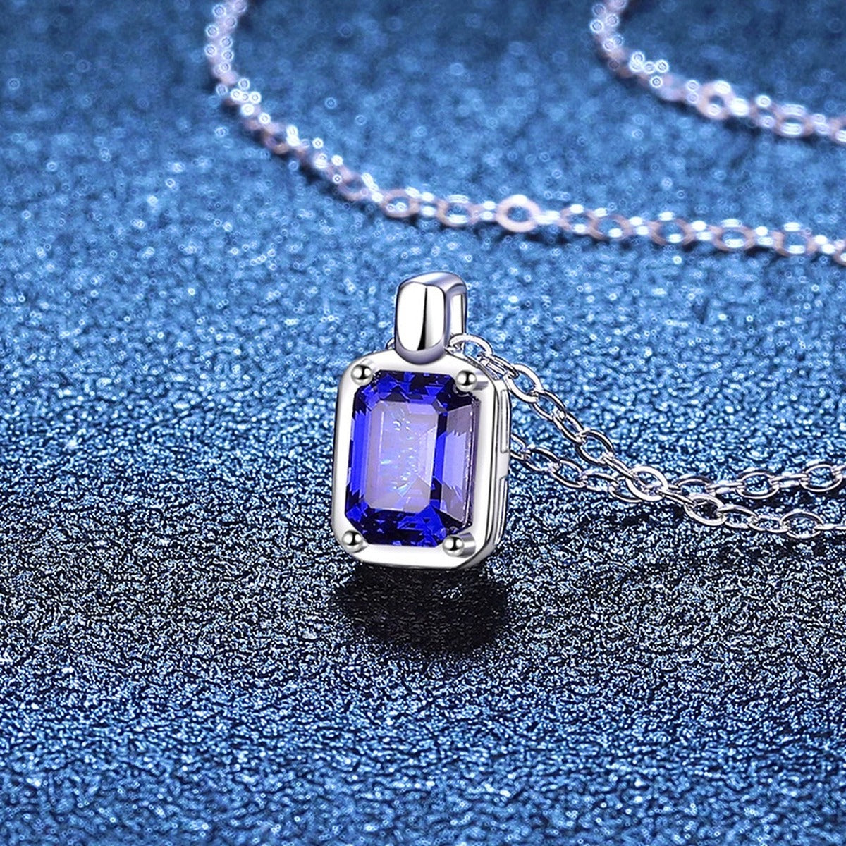 Emerald Cut Lab-Grown Gemstone and Moissanite Pendant Necklace in White Gold-Plated S925 Sterling Silver blue background styling view