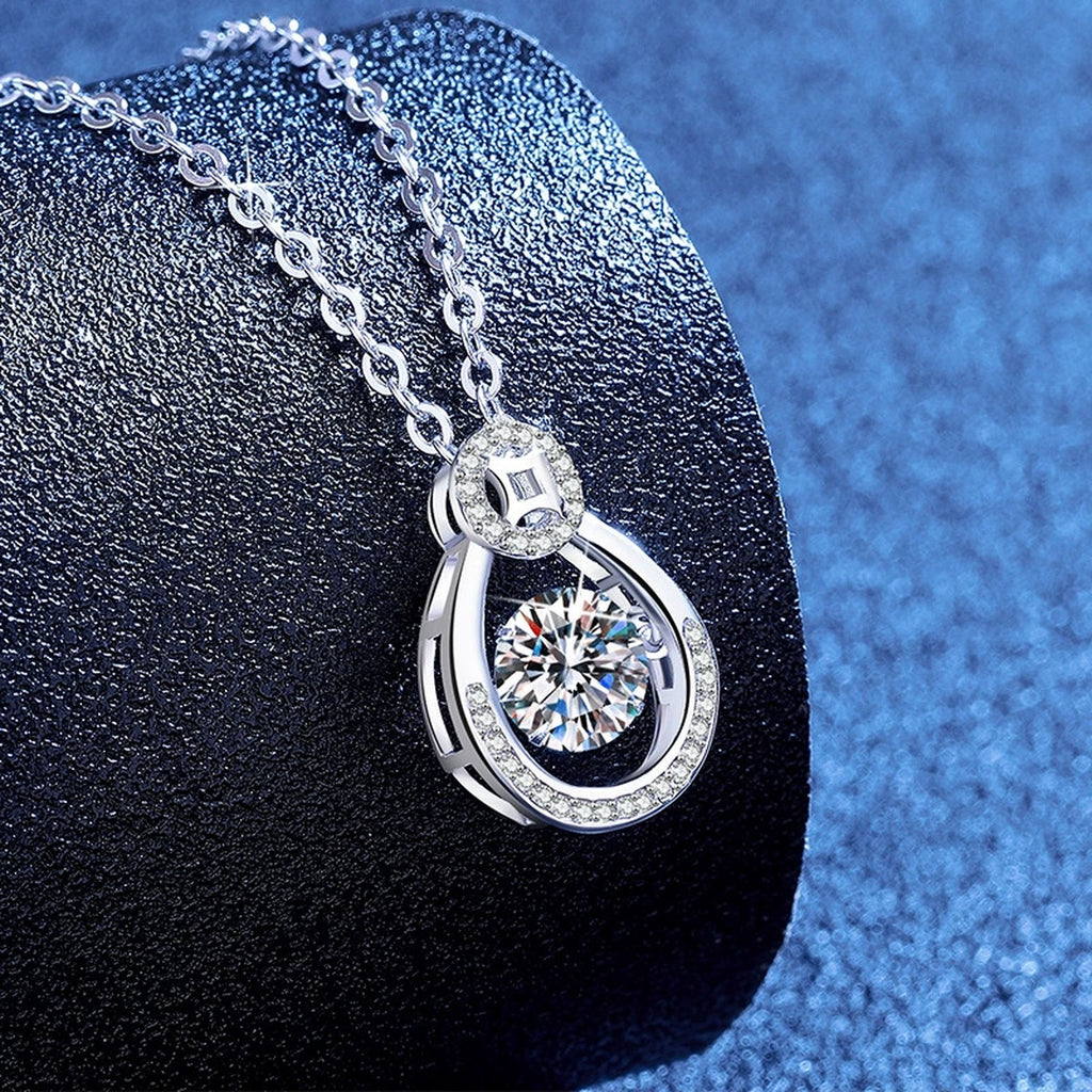 Oval Teardrop Moissanite Pendant Necklace with Cubic Zirconia in Platinum-Plated S925 Sterling Silver blue background angled view