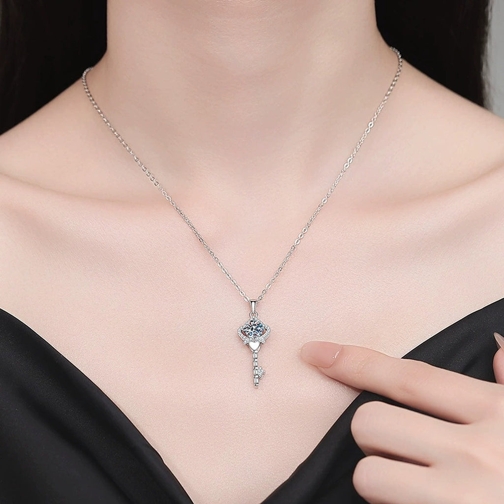 Ornate Key Moissanite Pendant Necklace with Cubic Zirconia in Platinum-Plated S925 Sterling Silver worn on neckline by model