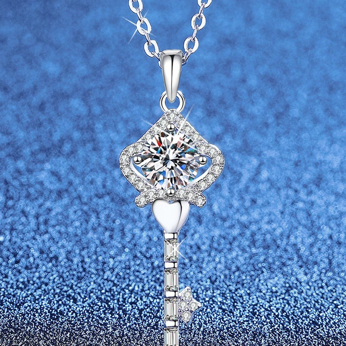 Ornate Key Moissanite Pendant Necklace with Cubic Zirconia in Platinum-Plated S925 Sterling Silver blue background angled view