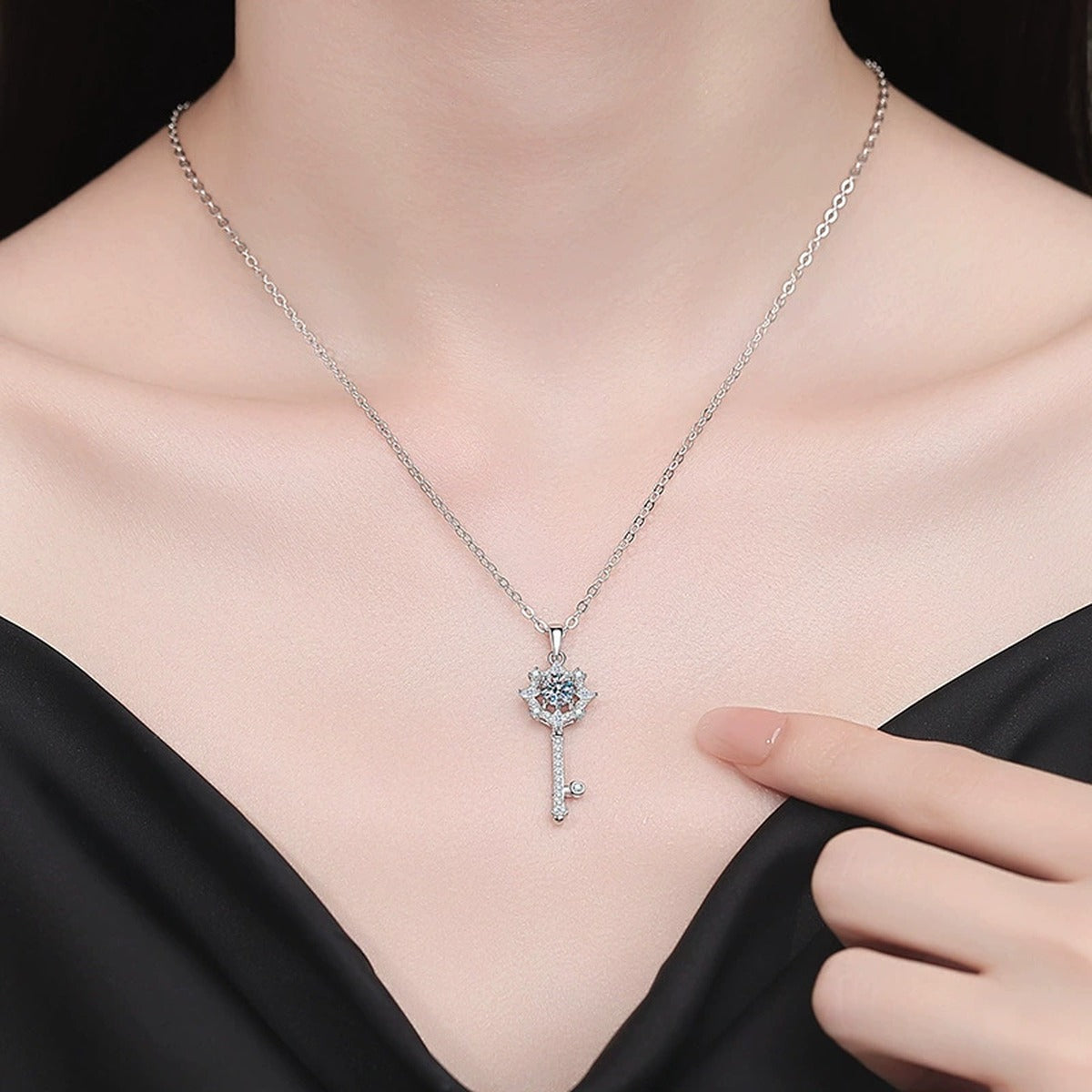 Snowflake Key Moissanite Pendant Necklace with Cubic Zirconia in Platinum-Plated S925 Sterling Silver worn on neckline by model