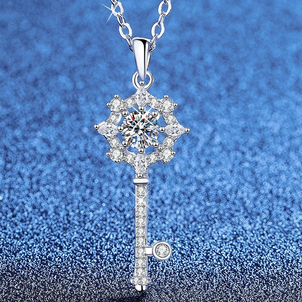 Snowflake Key Moissanite Pendant Necklace with Cubic Zirconia in Platinum-Plated S925 Sterling Silver blue background angled view