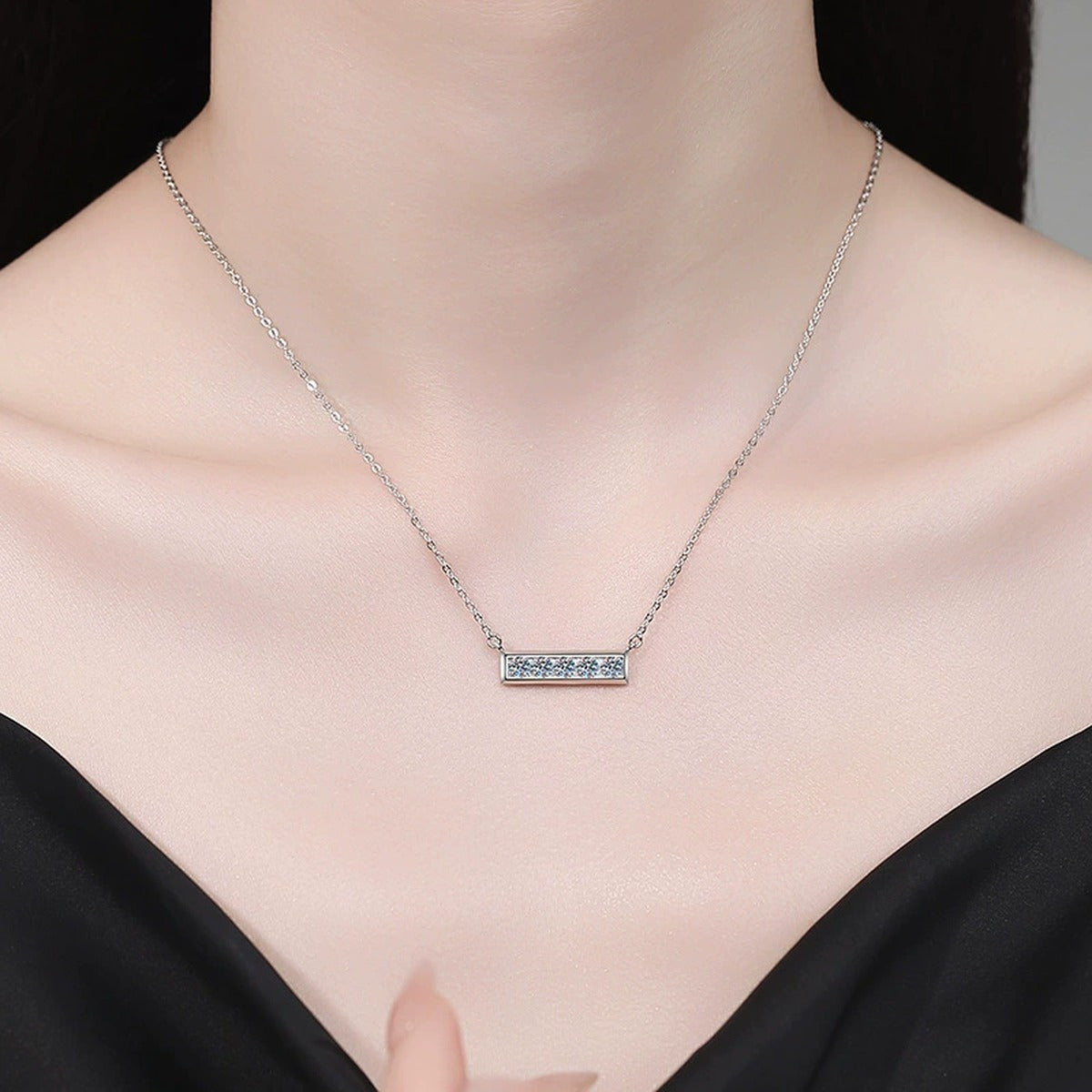 Five-Stone Moissanite Bar Necklace in Platinum-Plated S925 Sterling Silver worn on neckline by model