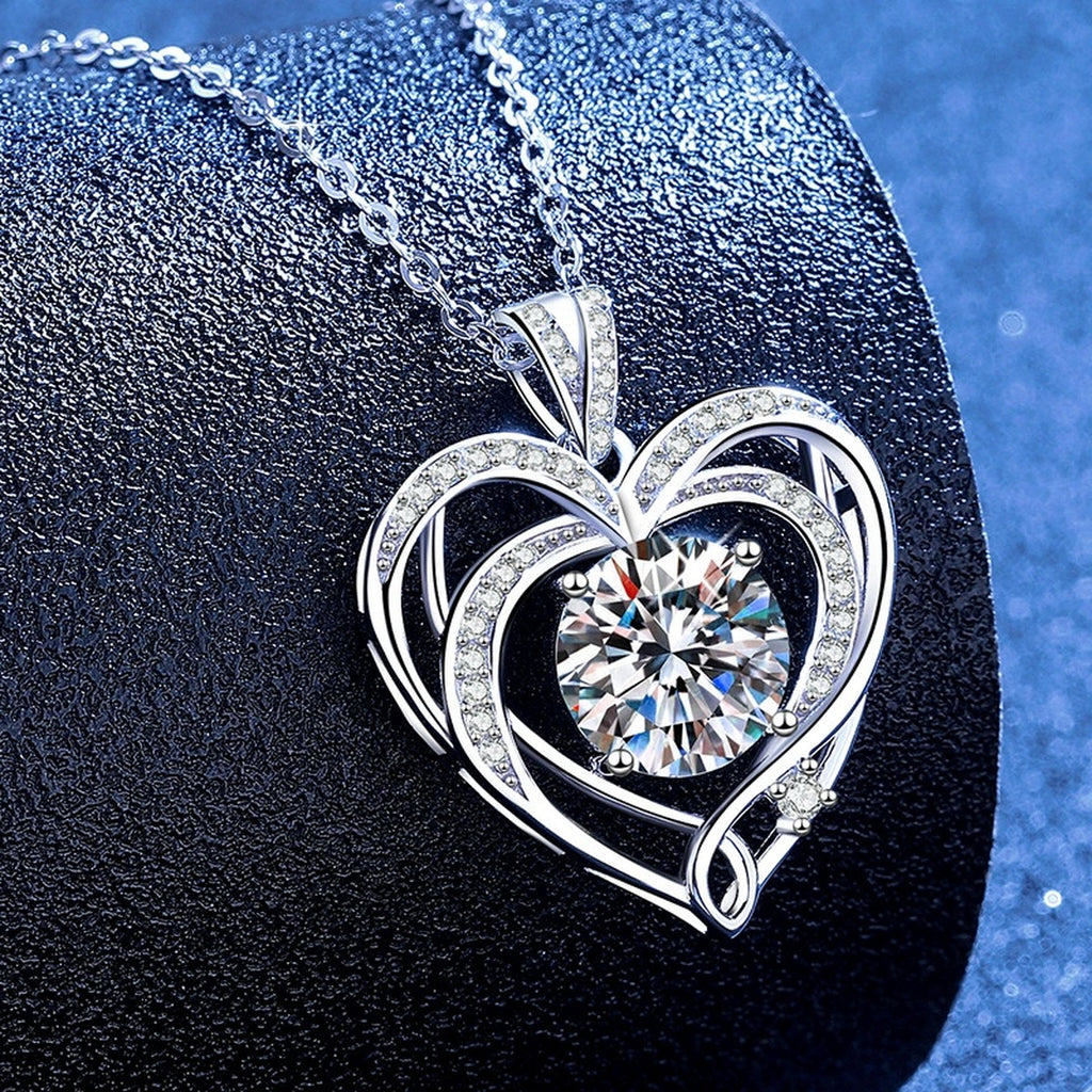 Open Heart Moissanite Pendant Necklace with Cubic Zirconia in Platinum-Plated S925 Sterling Silver blue background angled view