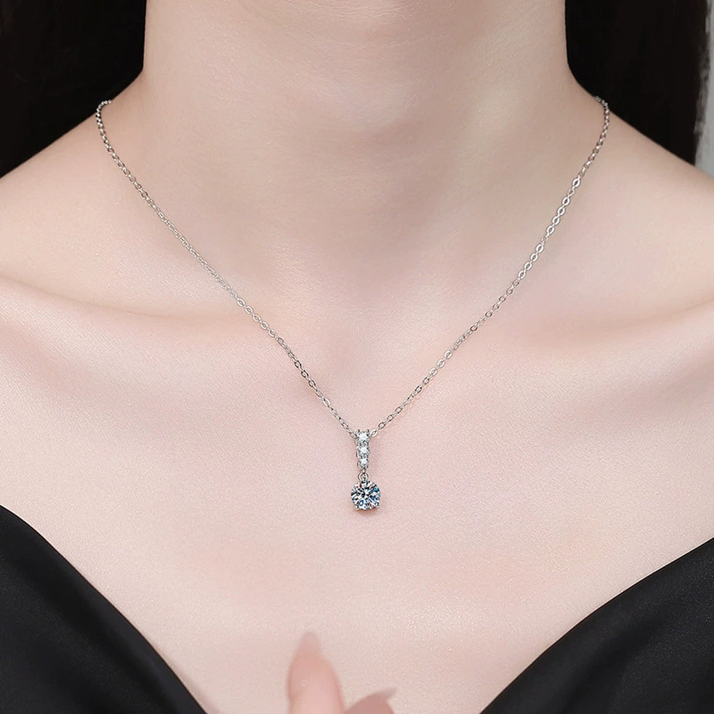 Graduated Drop Moissanite Pendant Necklace with Cubic Zirconia in Platinum-Plated S925 Sterling Silver worn on neckline by model