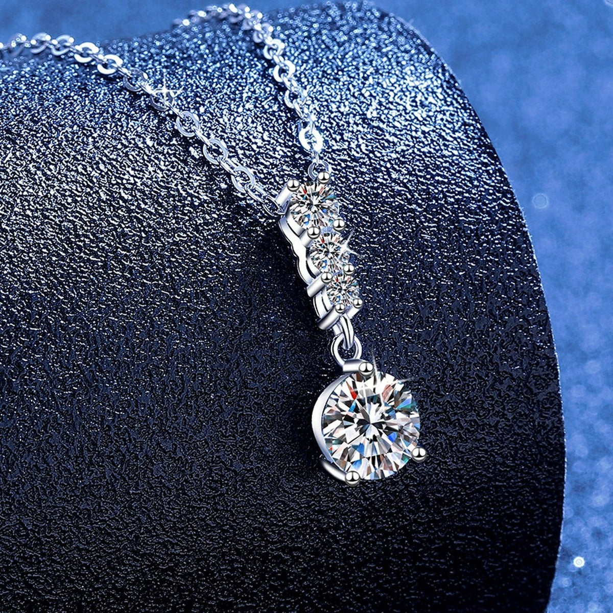Graduated Drop Moissanite Pendant Necklace with Cubic Zirconia in Platinum-Plated S925 Sterling Silver blue background product view
