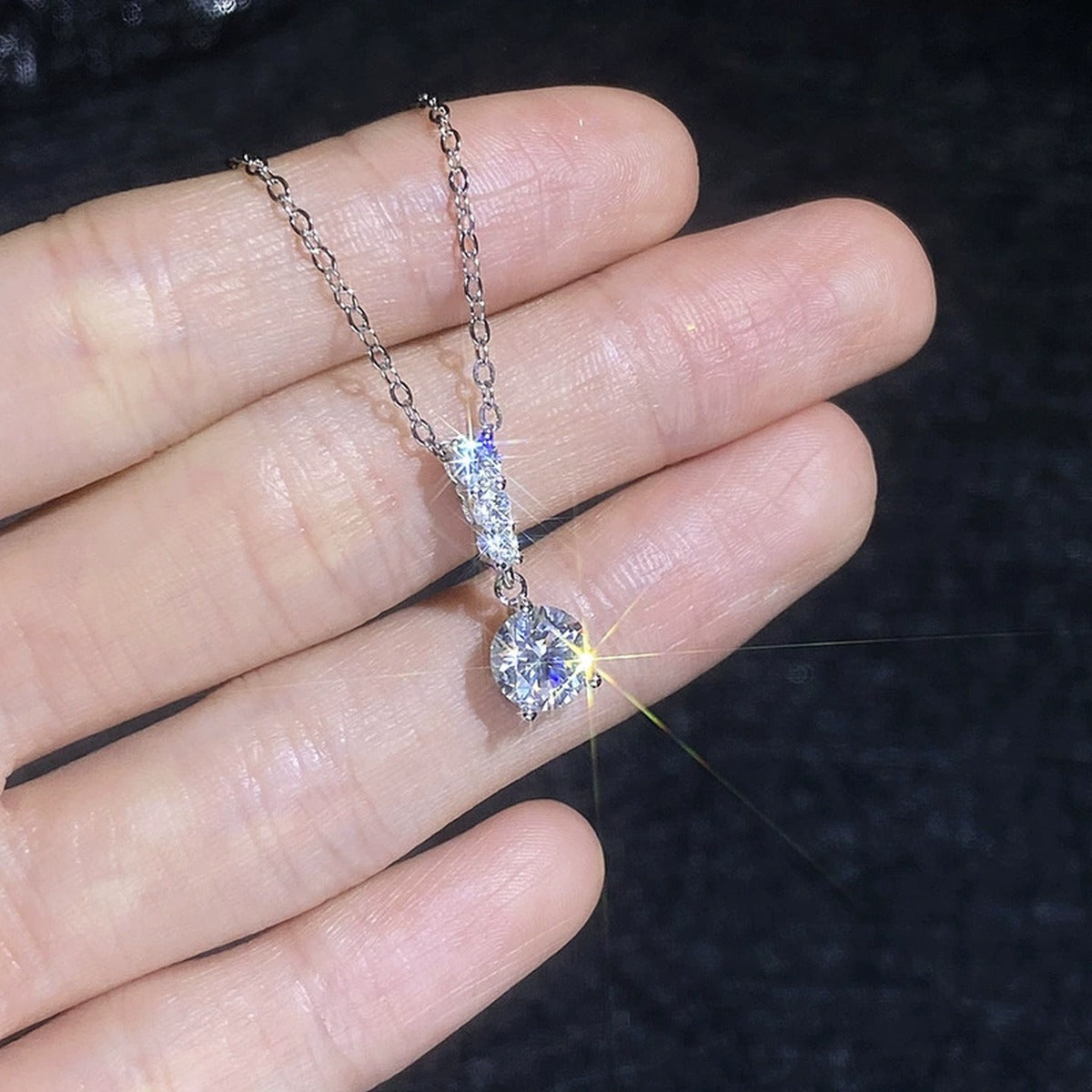 Graduated Drop Moissanite Pendant Necklace with Cubic Zirconia in Platinum-Plated S925 Sterling Silver close-up product detail view