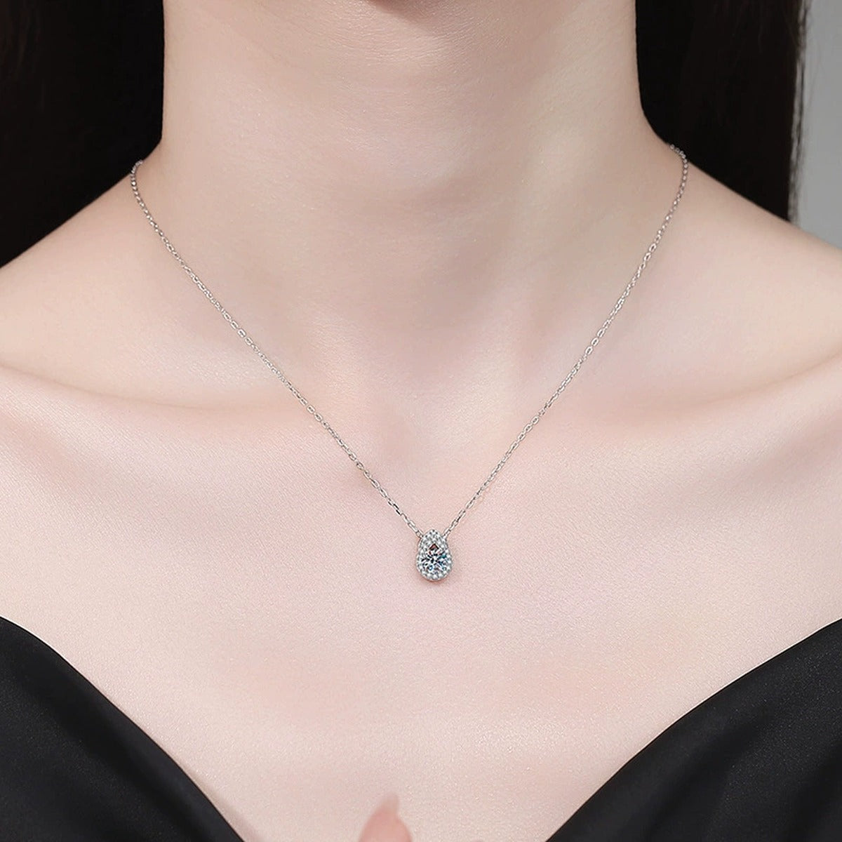 Pear Teardrop Moissanite Pendant Necklace with Cubic Zirconia in Platinum-Plated S925 Sterling Silver worn on neckline by model