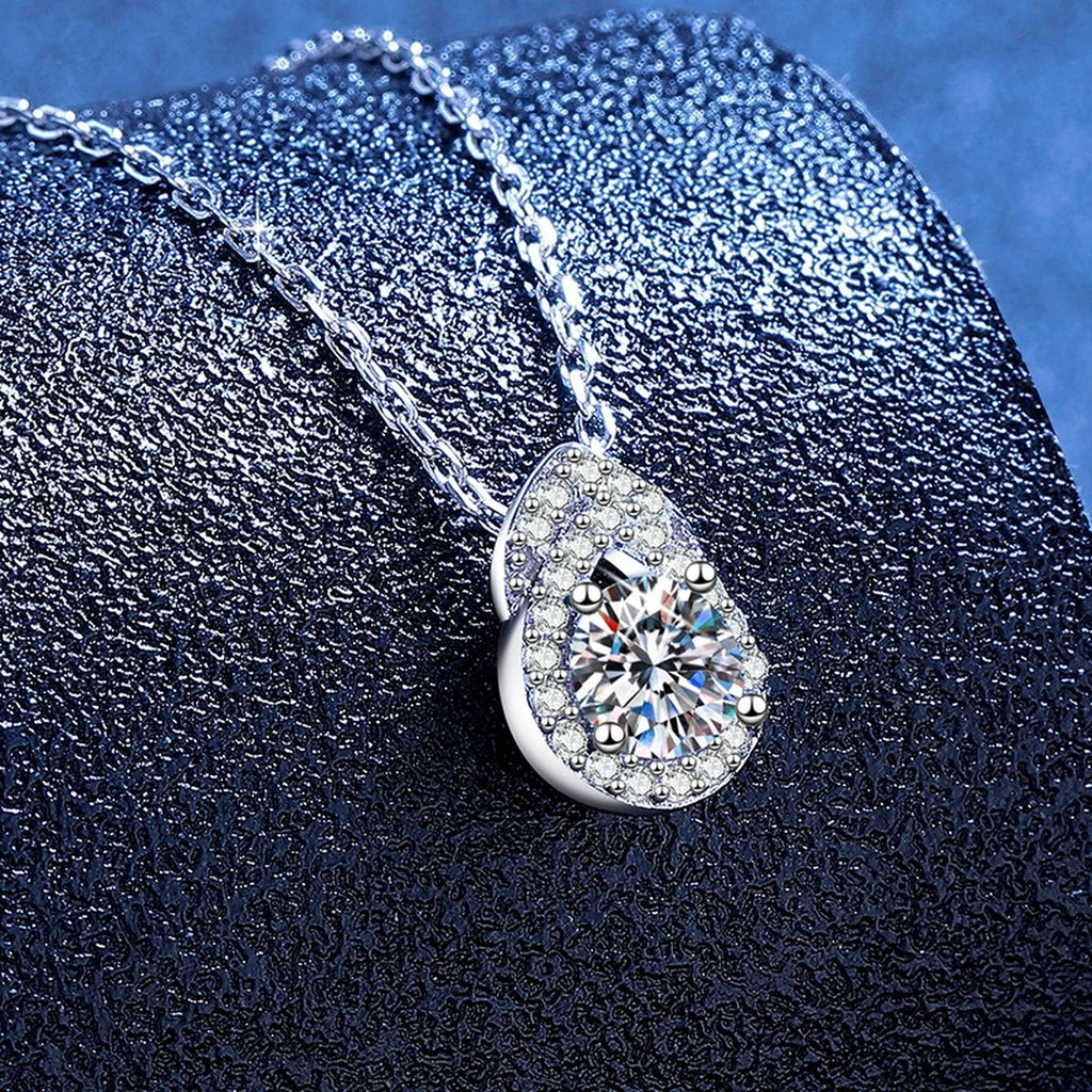 Pear Teardrop Moissanite Pendant Necklace with Cubic Zirconia in Platinum-Plated S925 Sterling Silver blue background angled view