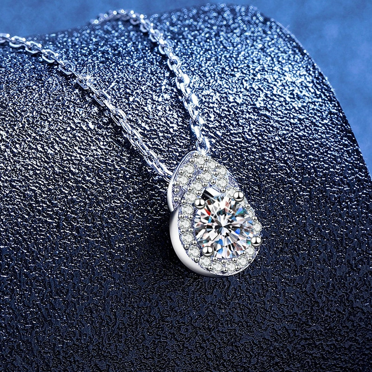 Pear Teardrop Moissanite Pendant Necklace with Cubic Zirconia in Platinum-Plated S925 Sterling Silver blue background angled view