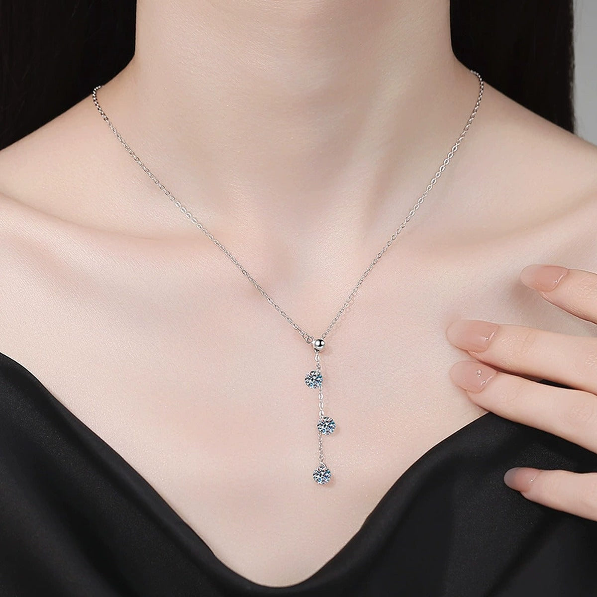Triple Moissanite Drop Necklace in Platinum-Plated S925 Sterling Silver worn on neckline by model