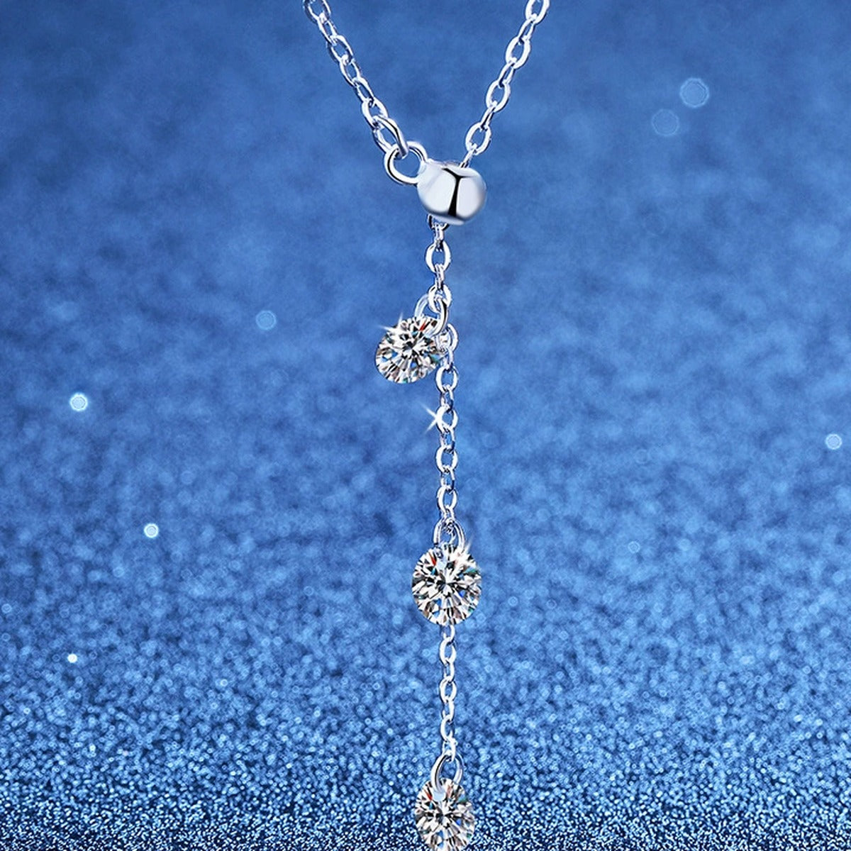 Triple Moissanite Drop Necklace in Platinum-Plated S925 Sterling Silver blue background product view
