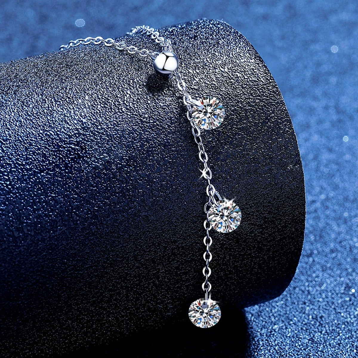 Triple Moissanite Drop Necklace in Platinum-Plated S925 Sterling Silver blue background angled view