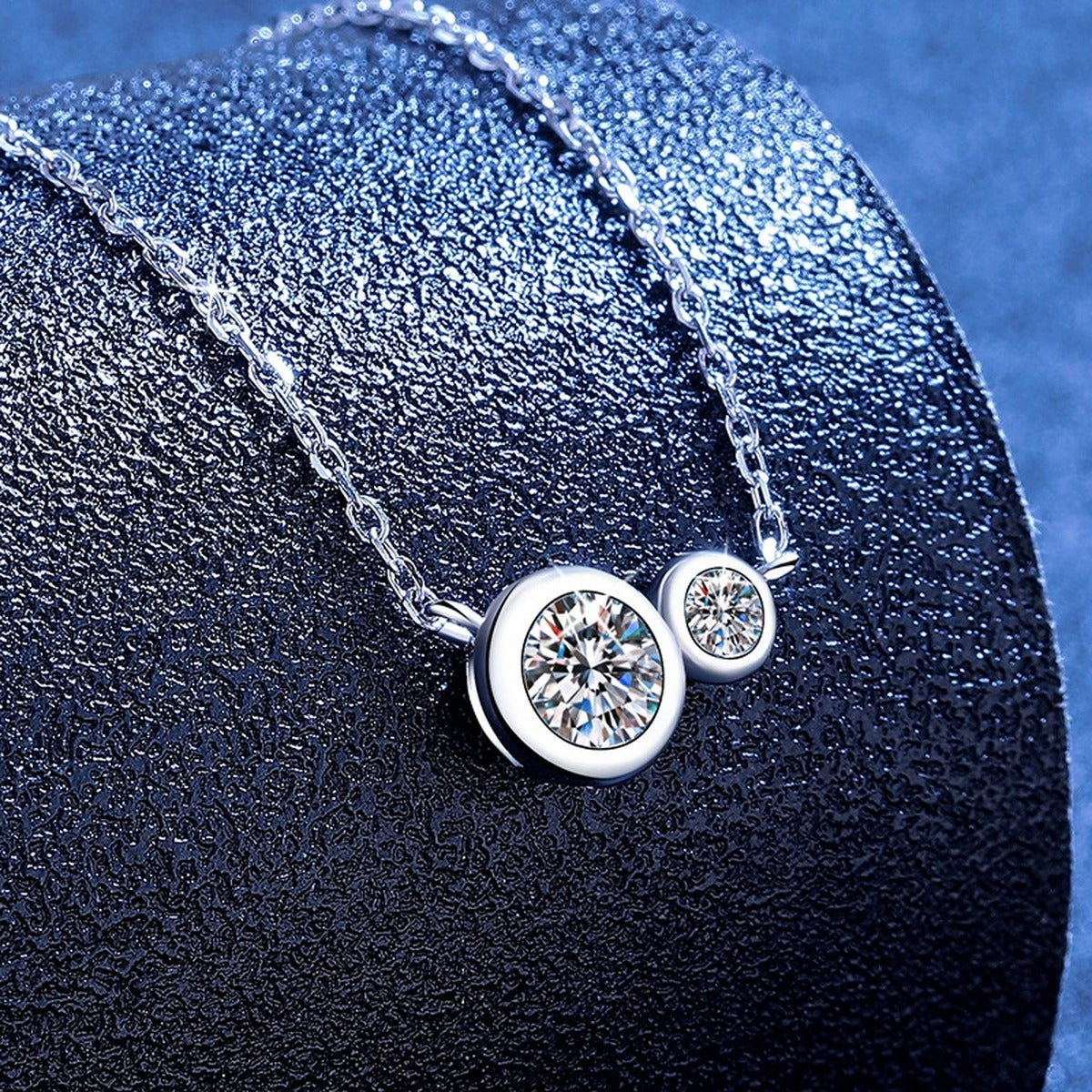 Two-Stone Moissanite Bypass Necklace in Platinum-Plated S925 Sterling Silver blue background angled view
