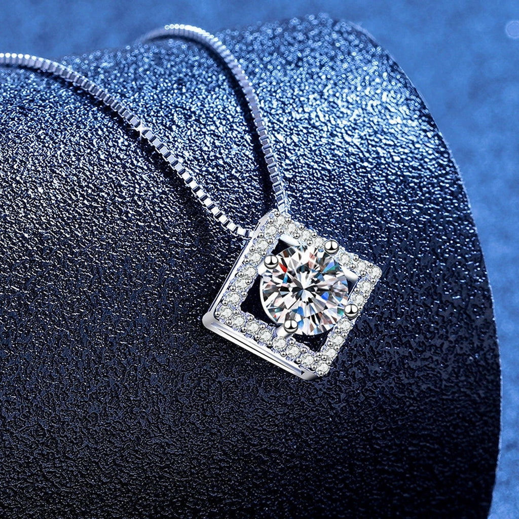 Diamond Halo Moissanite Pendant Necklace with Cubic Zirconia in Platinum-Plated S925 Sterling Silver blue background angled view