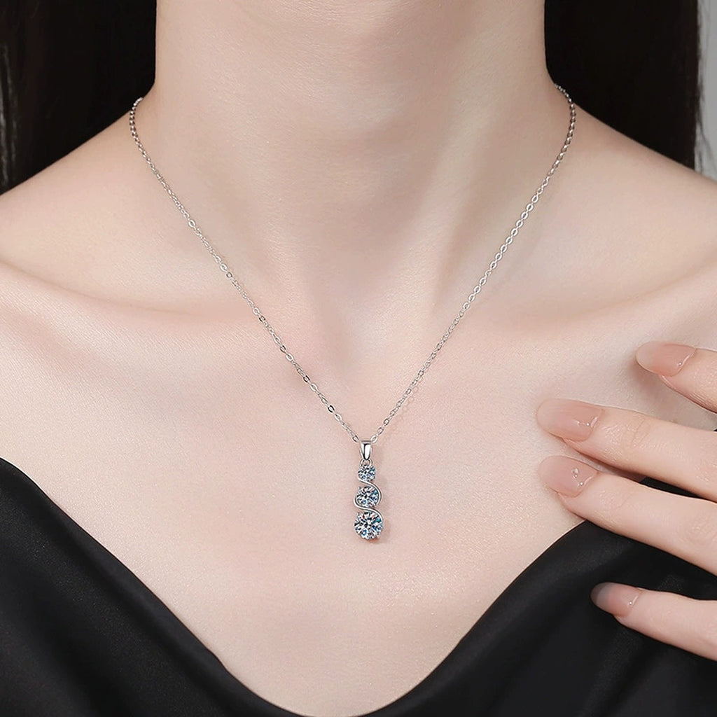 Three-Stone Graduated Moissanite Pendant Necklace in Platinum-Plated S925 Sterling Silver worn on neckline by model