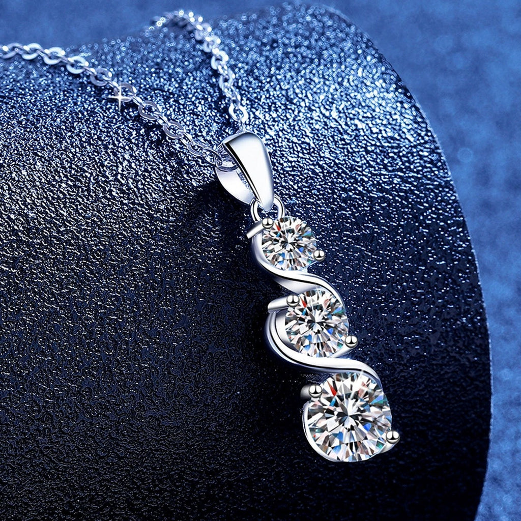 Three-Stone Graduated Moissanite Pendant Necklace in Platinum-Plated S925 Sterling Silver blue background angled view