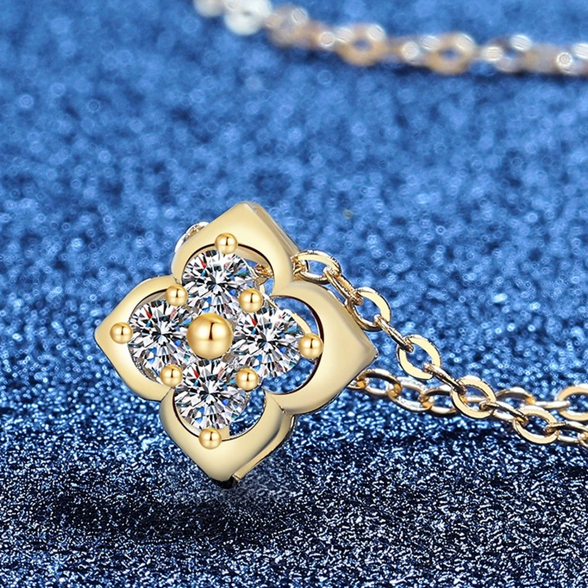 Clover Moissanite Pendant Necklace in S925 Sterling Silver blue background close-up view