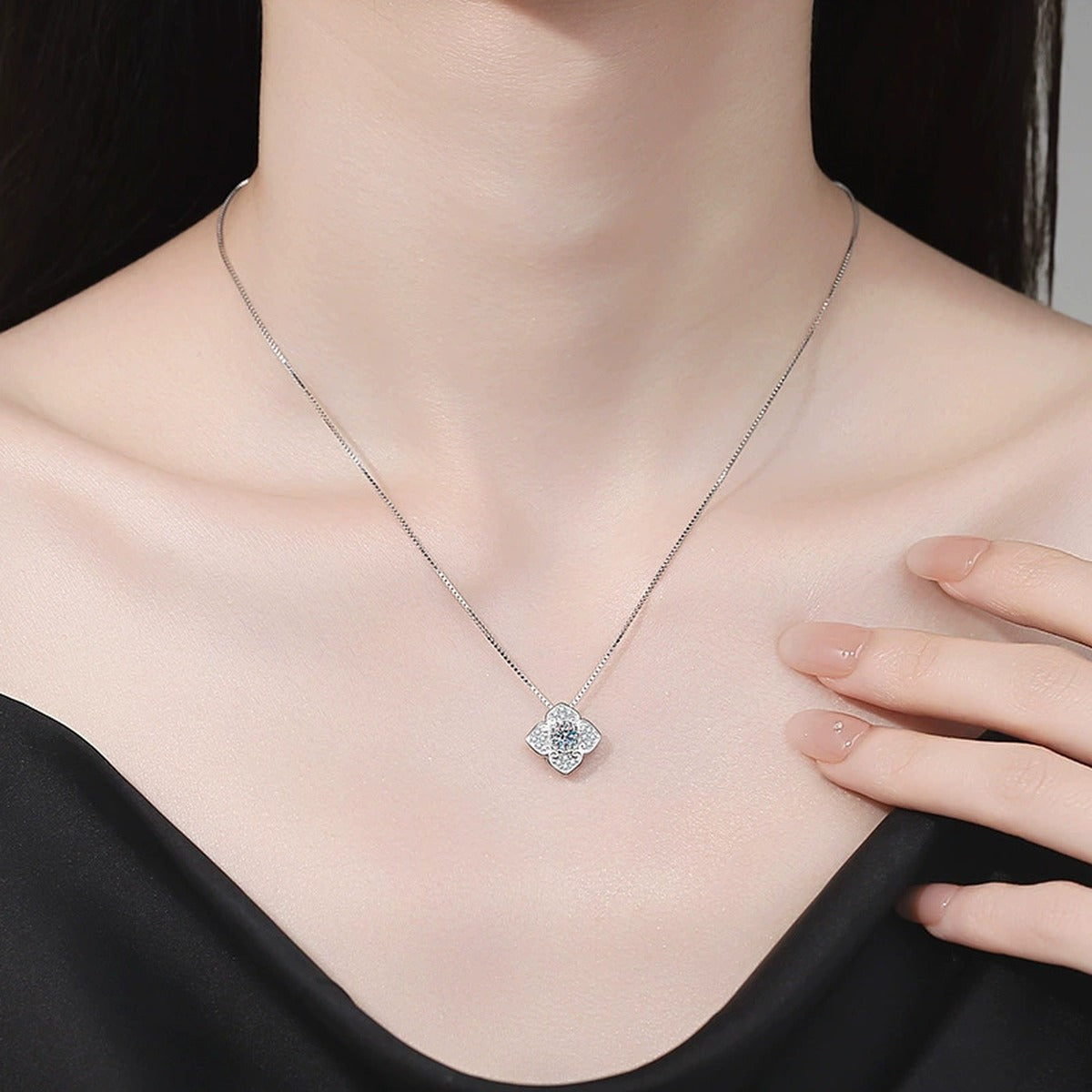 Quatrefoil Clover Moissanite Pendant Necklace with Cubic Zirconia in Platinum-Plated S925 Sterling Silver worn on neckline by model