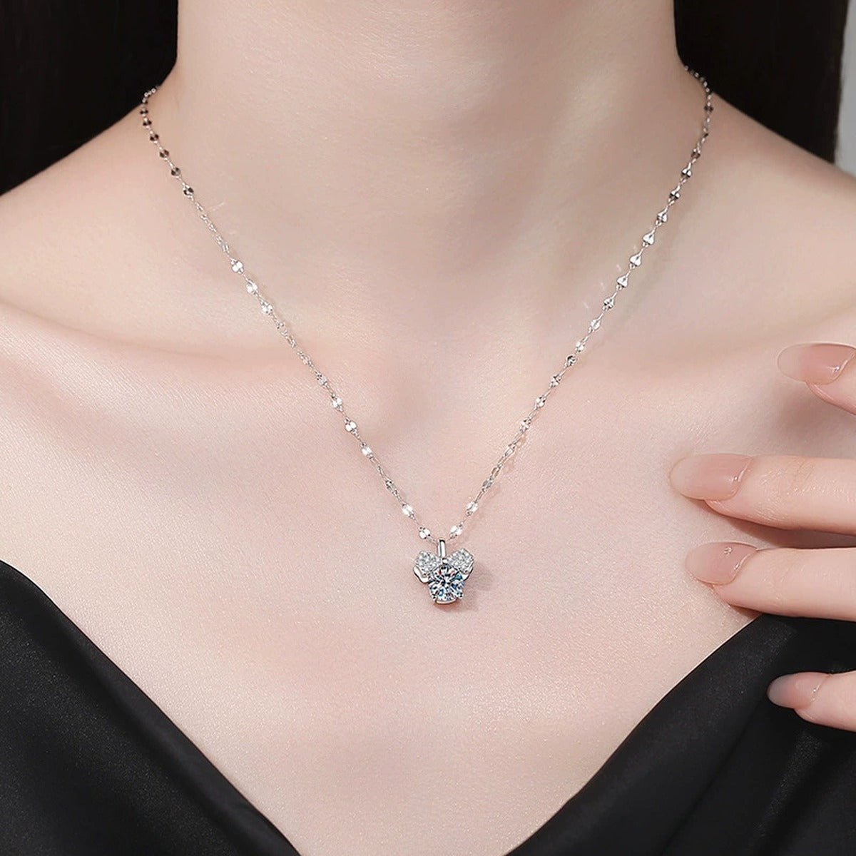 Bow Moissanite Pendant Necklace with Cubic Zirconia in Platinum-Plated S925 Sterling Silver worn on neckline by model